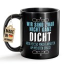 Schwarze Tasse mit Spruch - Wir sind nicht ganz dicht